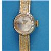 Image 1 : A lady's 18k gold Wega wrist watch, with circular dial and textured bracelet...