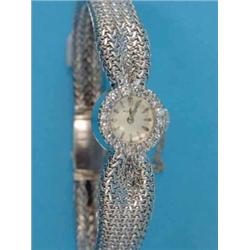 A lady's 18ct white gold Rotary cocktail watch, with diamond set bezel and textured bracelet...