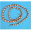 Image 1 : A single row graduated coral and gold bead necklace, 16ins...