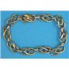 Image 1 : A French 2-colour gold fancy link bracelet, the alternating pear shaped links set small diamonds...
