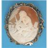 Image 1 : A Victorian shell cameo brooch, carved with a study of a seated putti scribe, in gold scrolled fr...