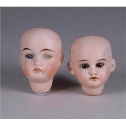 TWO SMALL BISQUE DOLL HEADS