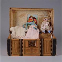 BISQUE DOLL WITH TRUNK