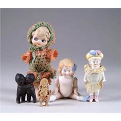 BLACK KEWPIE HUGGERS, JOINTED BISQUE RABBIT, AND THREE OTHER BISQUE DOLLS
