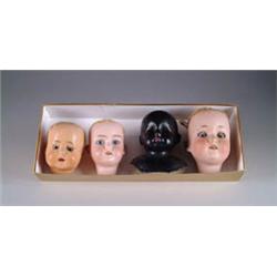 FOUR DOLL HEADS