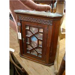 A late 19th century mahogany hanging corner cupboard, H 49cms W 43cms...