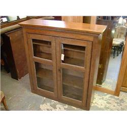 An early 19th century oak bookcase enclosed by glazed doors, H 108cms W 99cms...