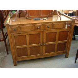 An Arts and Crafts style oak sideboard by Waring & Gillows, H 105cms W 130cms...