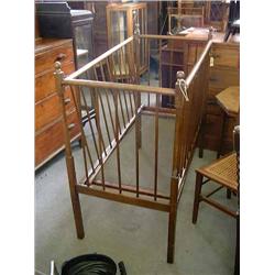 A beech child's cot, with spindle supports, on square legs, H 111cms L 121cms...