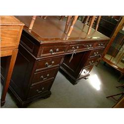 A reproduction mahogany pedestal desk, fitted nine drawers, on bracket feet, W 138cms D 77cms...