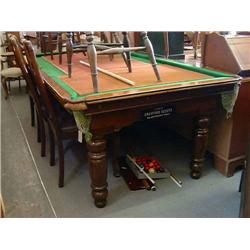 An early 20th century oak-framed snooker table with associated cues and balls, L 226cms D 118cms...