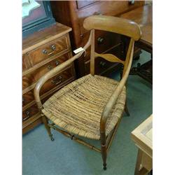 A late 19th century Continental walnut cane seat elbow chair...