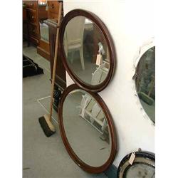 A near pair of mahogany oval wall mirrors, the largest H 70 cms W 82 cms...