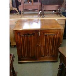 A linenfold-carved oak television cabinet, H 85cms W 92cms, and an oak sideboard...