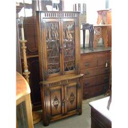 An oak standing corner cupboard, with floral carved decoration, H 175cm W 77cm...