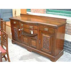 A late Victorian carved walnut sideboard (lacking mirrored back), H 102cms W 179cms...