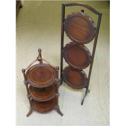Two mahogany cake stands and a gilt-framed mirror. H 88.5cms and 60cms (stands)...