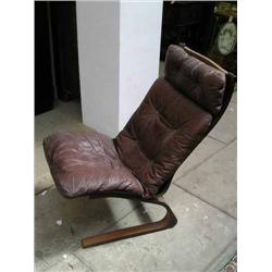 A Danish rosewood cantilever easy chair with leather cushions...