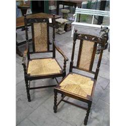 A set of six Carolean style carved oak dining chairs....