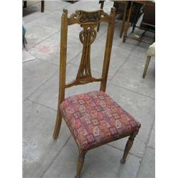 A set of four Victorian carved beech dining chairs, in the Art Nouveau taste....