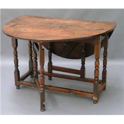 An 18th century walnut and oak oval gateleg table, W 105cms D 44.5cms...