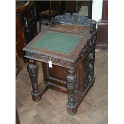 A Victorian carved oak davenport, H 99cms W 63.5cms...