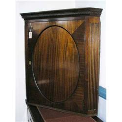 A George III style mahogany hanging corner cupboard enclosed by panelled door, H 107cms W 100cms...