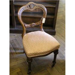 A pair of Victorian carved oak side chairs with balloon backs...