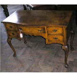 A Queen Anne style banded walnut serpentine dressing table on cabriole legs, H 79cms W 108cms...