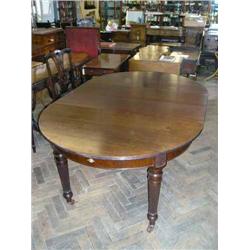 An Edwardian mahogany oval extending dining table on turned reeded legs (with two additional leav...