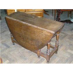 An oak oval gateleg table on baluster-turned underframe, L 140cms (max) W 122cms...