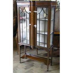 An Edwardian inlaid mahogany display cabinet enclosed by glazed doors, H 167.5cms W 90.5cms...