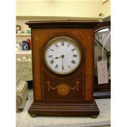 An Edwardian mahogany mantel timepiece having thirty-hour movement, H 25cms W 18cms, and one othe...