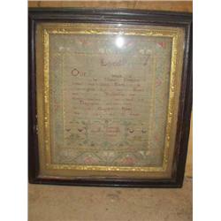 An 18th century sampler dated 1755 with The Lord's Prayer, (a.f.), 29cms x 25cms...