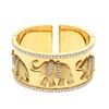 Image 1 : BRACELET: [1] 18 karat yellow and white gold hinged cuff style bangle bracelet with elephants and se