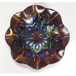 Purple Carnival glass dish decorated with …