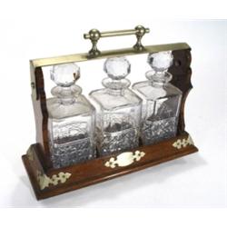 Brass cornered oak three bottle tantalus w…