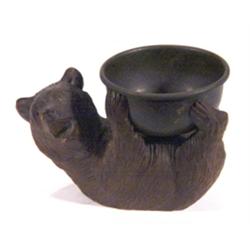 Carved Black Forest brown bear clutching a…