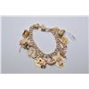 Image 1 : Ladies 10kt yellow gold double link charm bracelet with seventeen 10kt and 14kt charms plus one loos