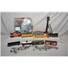 Image 1 : Selection of vintage tin toy trains including engine and six rolling stock cars, spot lamp plus a se