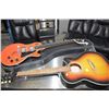 Image 1 : Unmarked electric guitar with hard case and a Trembita six string acoustic guitar