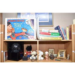 Two shelf lots including ceramic sailors, Hummel clocks, plasma ball, games including Johnny Astro e