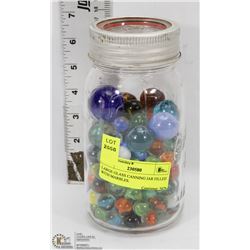 LARGE GLASS CANNING JAR FILLED WITH MARBLES.