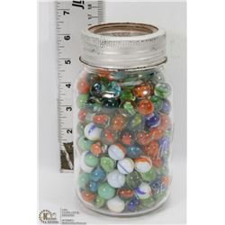 LARGE GLASS CANNING JAR FILLED WITH MARBLES.