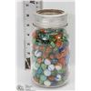 Image 1 : LARGE GLASS CANNING JAR FILLED WITH MARBLES.