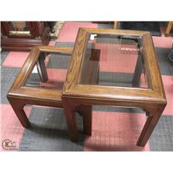 SET OF 2 OAK GLASS TOP END TABLES .