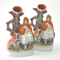 A pair of Victorian Staffordshire 'Little Red Riding Hood' spill vases, character seated beside t...