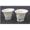 Image 1 : Two near-matching Kangxi 'blanc de chine' libation cups, moulded with prunus in bold relief, 3.5i...