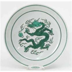 A 'famille verte' bowl, Kangxi mark and period, painted with a dragon and flaming pearl in green...