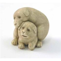 An ivory netsuke, carved as two puppies, one embracing the other, signed, 1.5in....